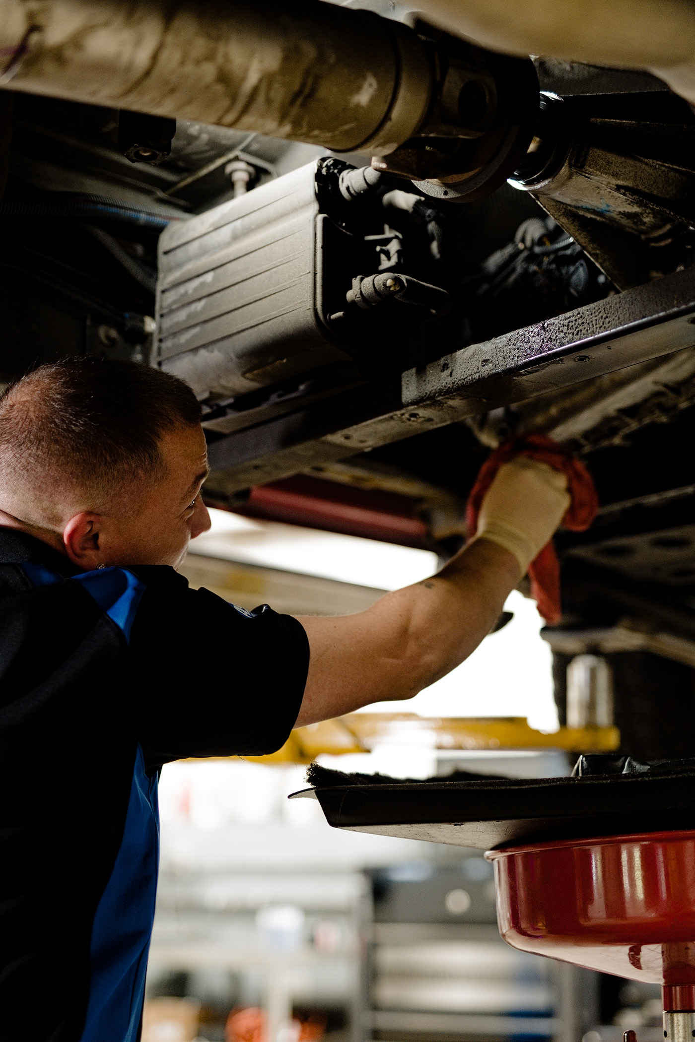 ASE-certified technician performing a professional transmission repair beneath a vehicle at Primary Care Auto Repair.