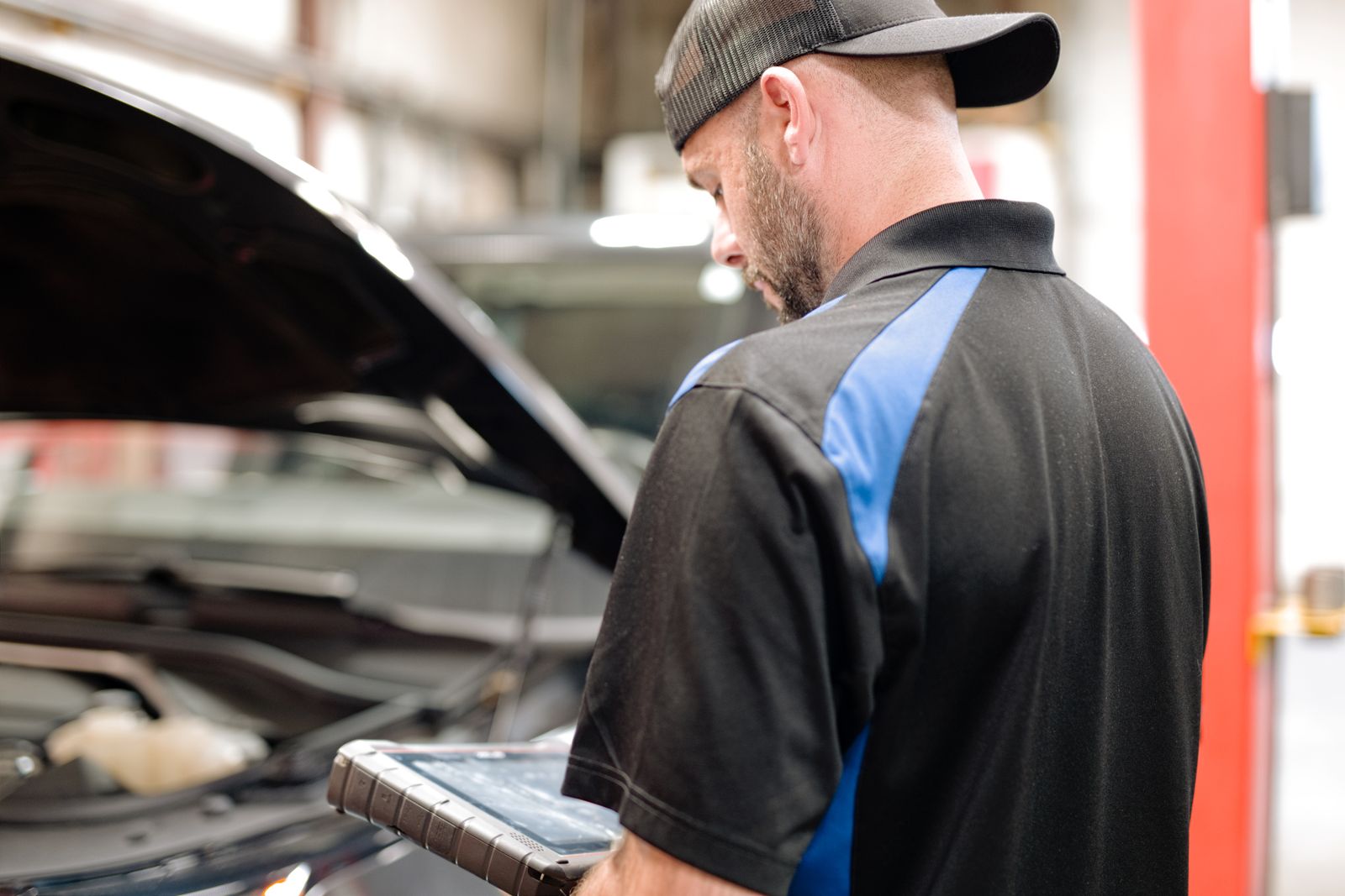Technician using a scan tool on a vehicle