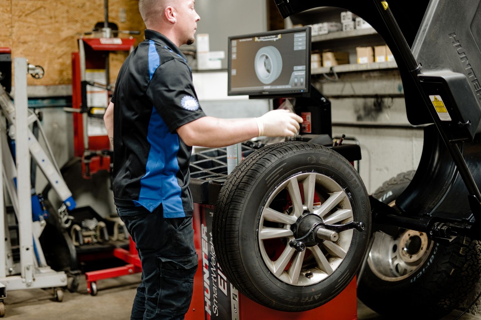 Technician using the tire balancer
