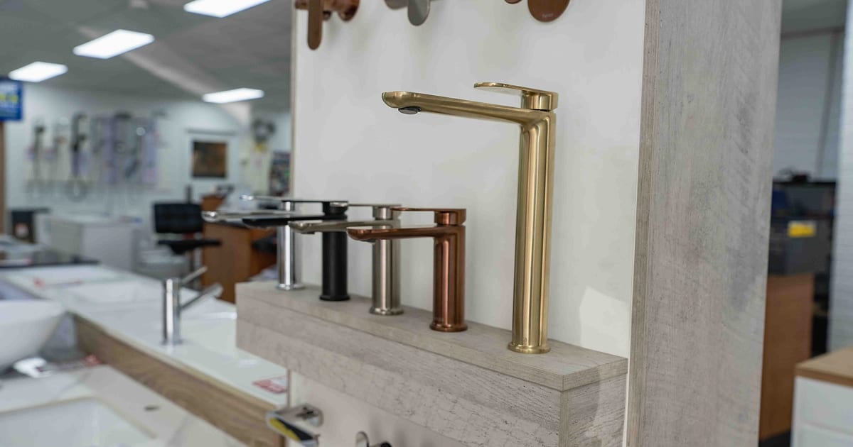 Bathroom tapware in brass, copper, black and chrome finishes on display.