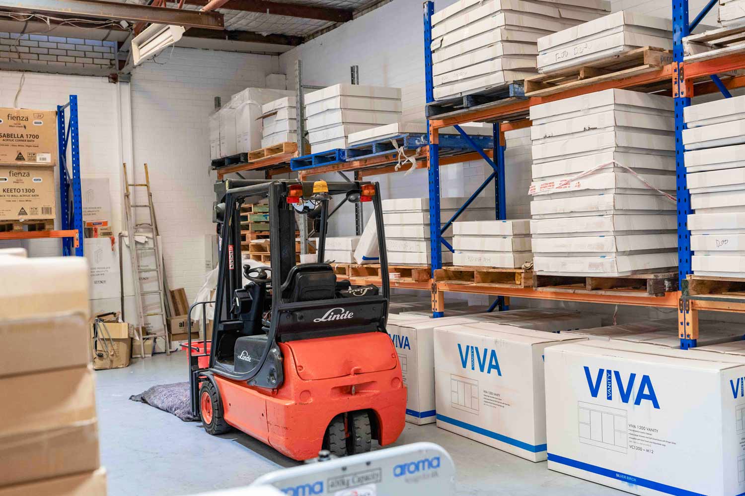 Boxed renovation stock and a forklift inside the Mike's Back Shed warehouse.