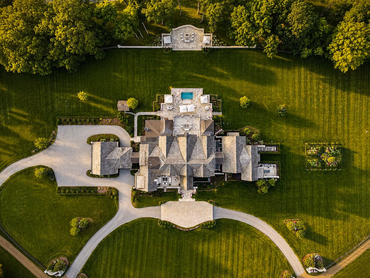 Top-down aerial view of a Castle Homes estate with a pool and manicured grounds.