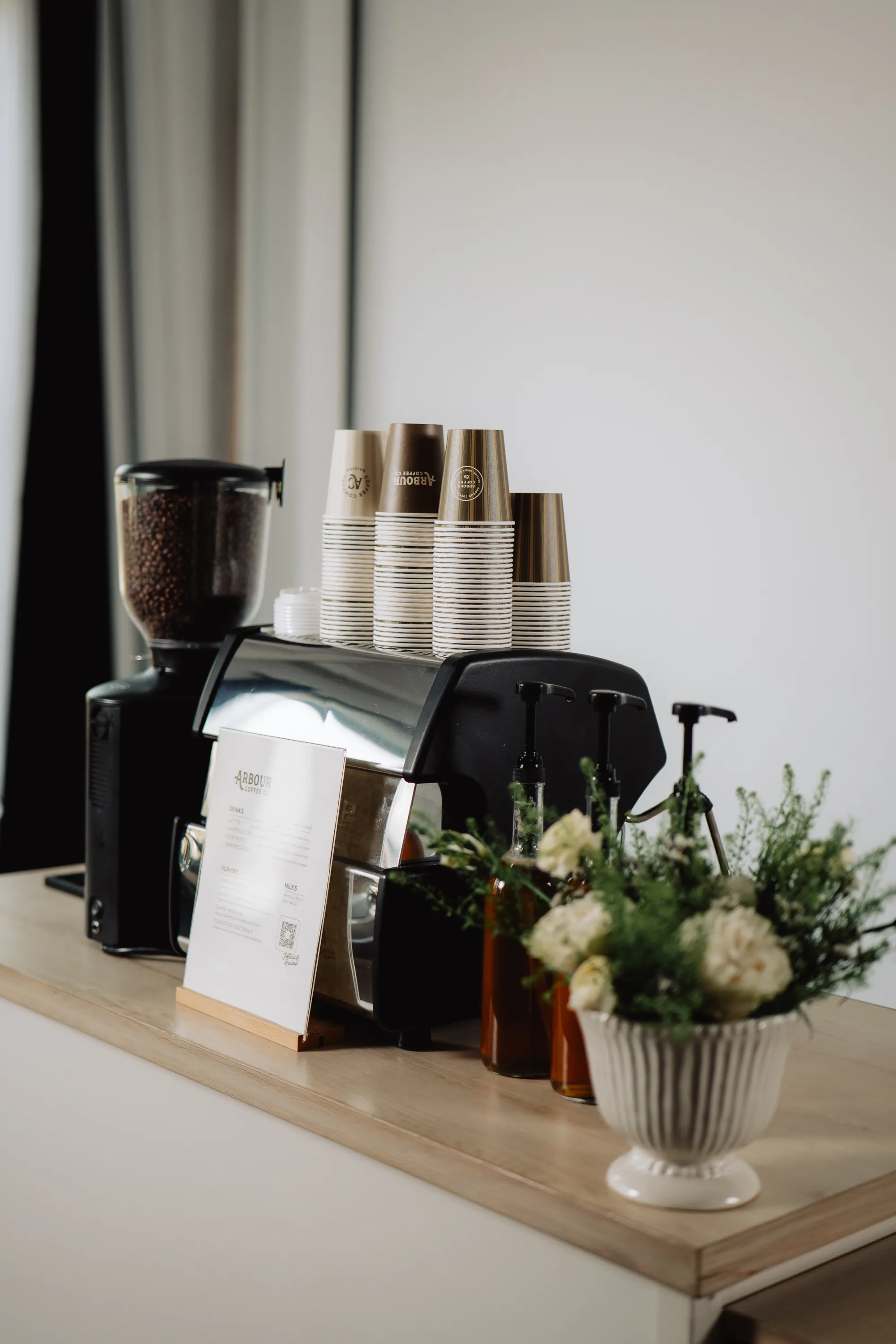 Iced coffee beside white wedding florals at a Greensboro reception