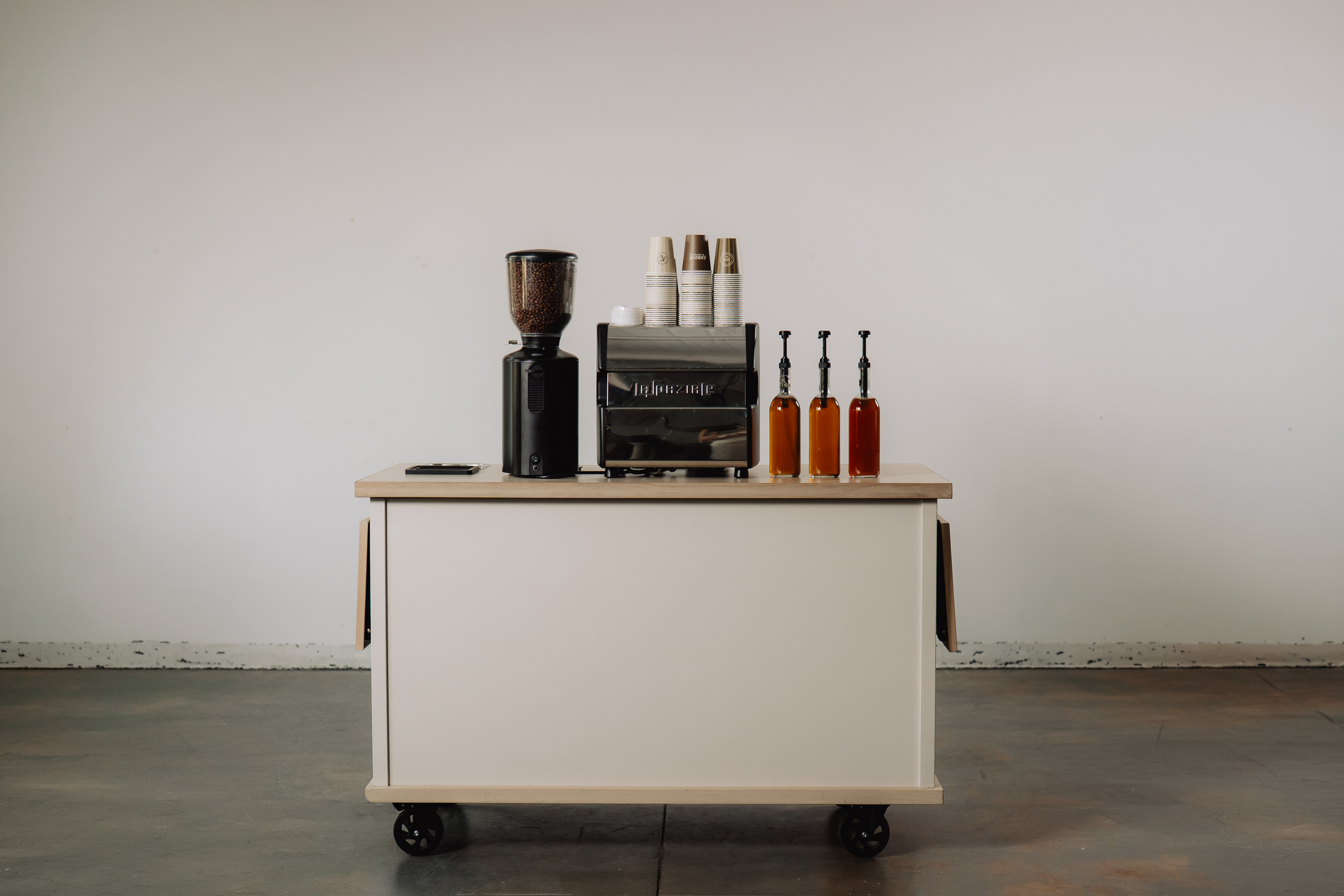 Couple beside the Arbour coffee cart at a private event