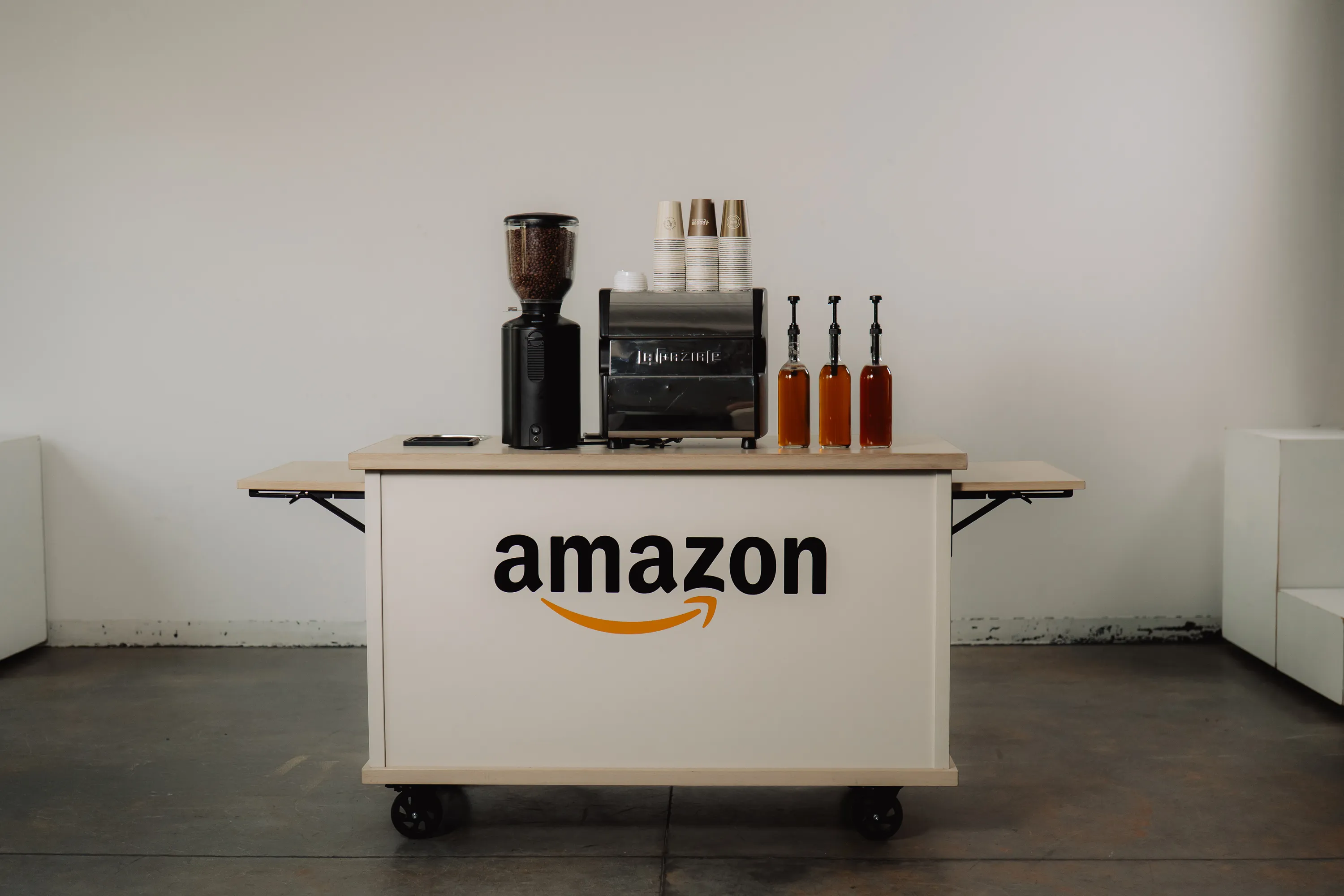 Arbour's white catering espresso cart styled with a menu and flowers