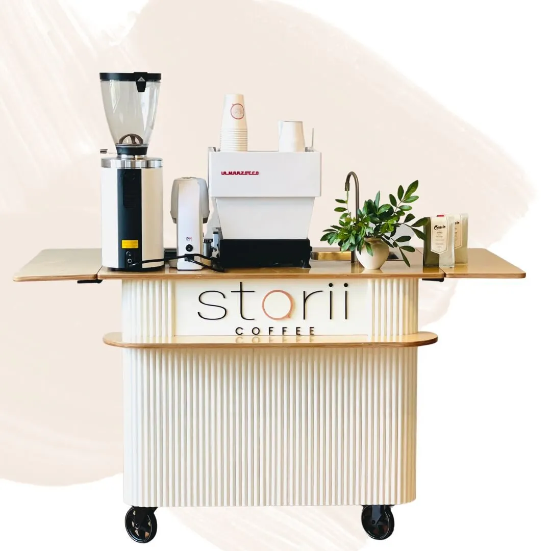 The Storii Coffee cart with espresso machine, grinder, and greenery