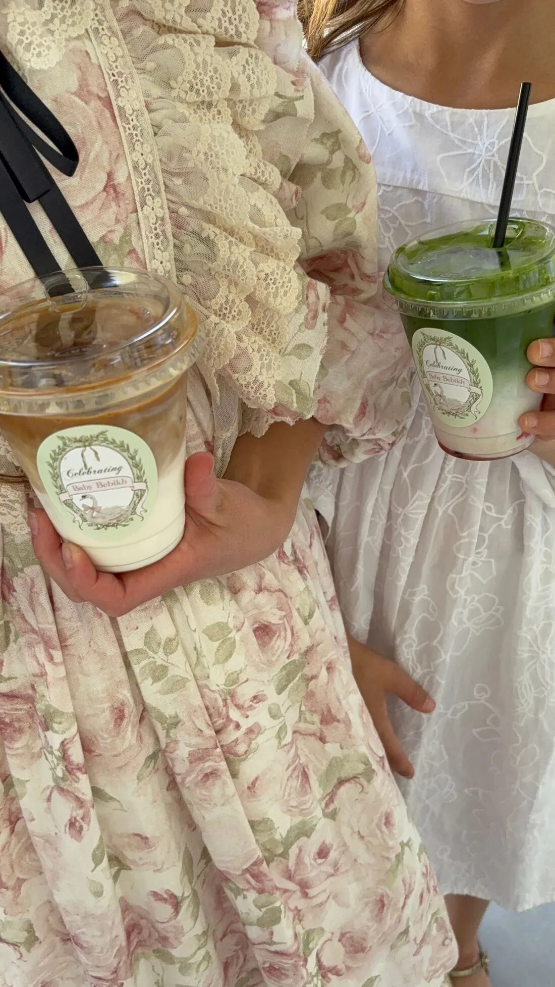 Guests holding custom-labeled iced latte and matcha drinks