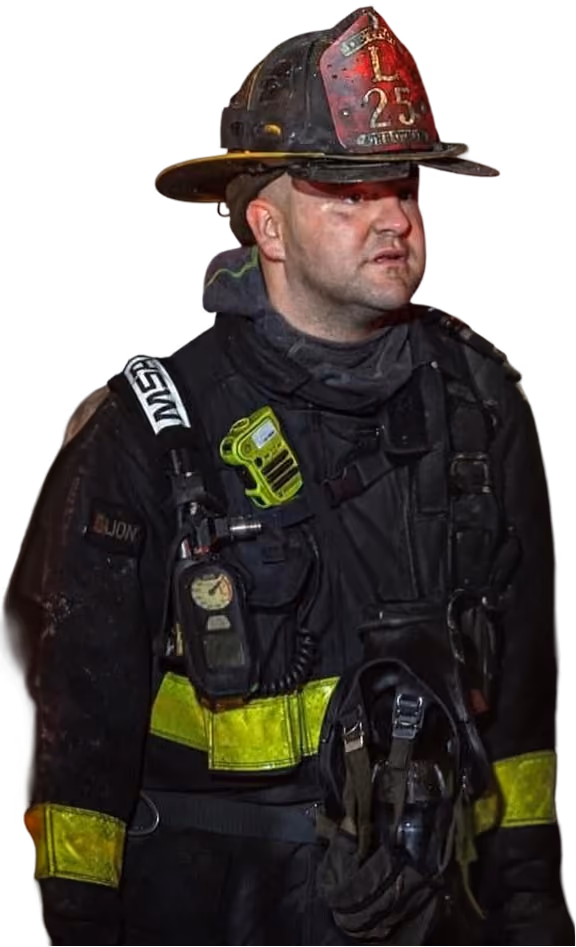 Scott "Zig" Ziegler in full firefighter protective gear with helmet, radio, and breathing apparatus harness.