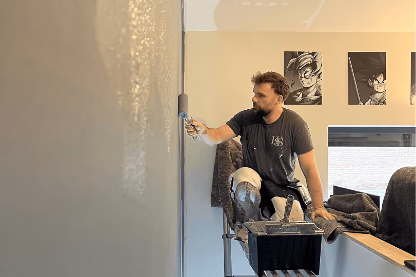 Professional painter painting an interior wall