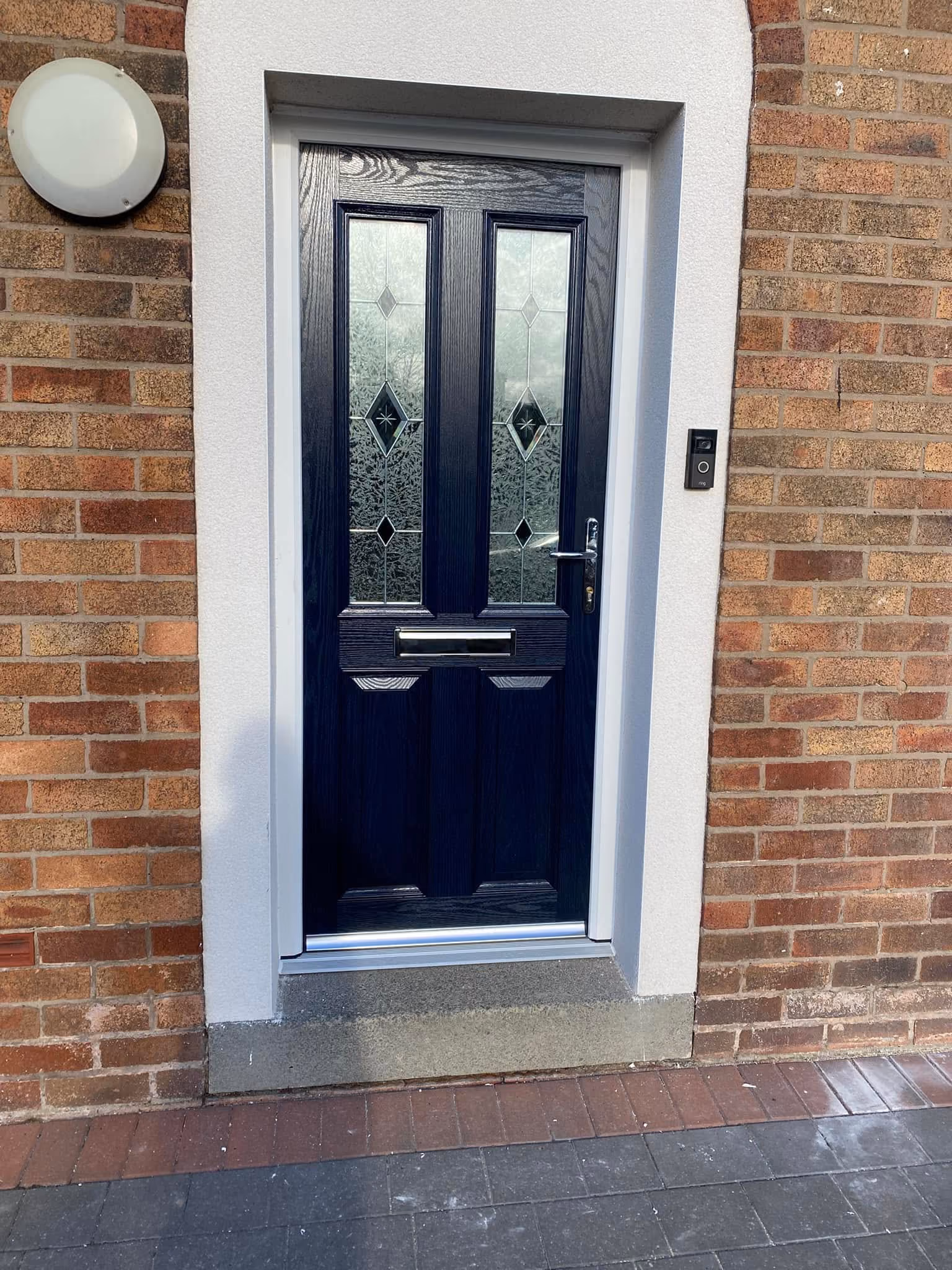 Navy blue composite front door with bar handle in a new glazed porch with tiled roof near Ormskirk
