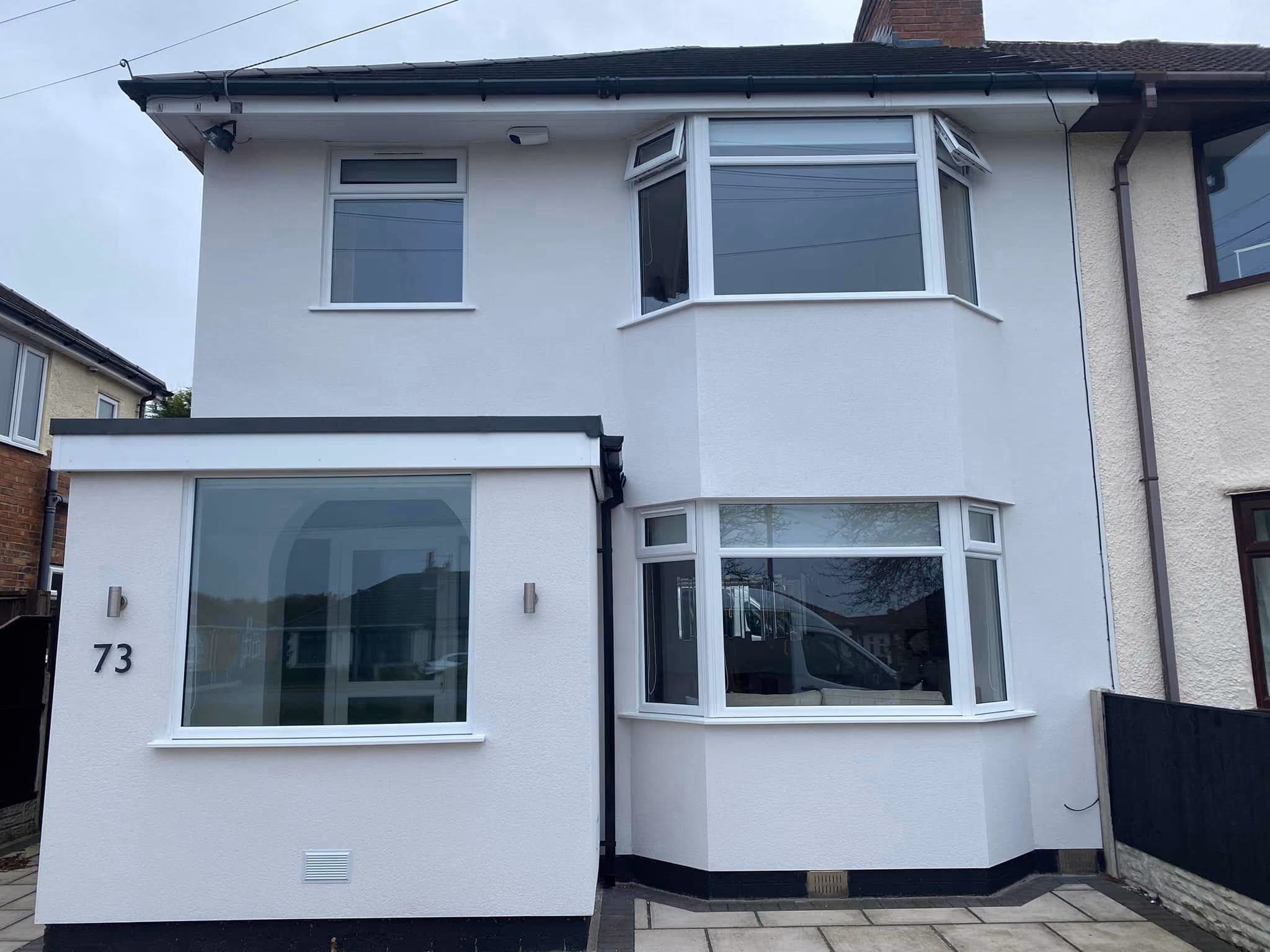 White uPVC bay windows and picture window fitted to a rendered semi detached house in Ormskirk