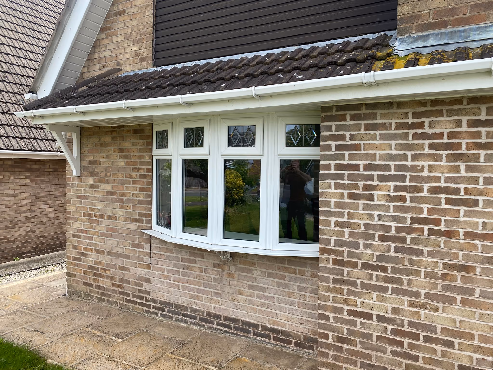 White uPVC bow window with decorative leaded top lights on a brick home near Ormskirk