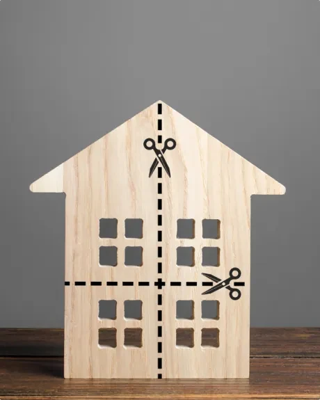 House model cut by scissors representing property disputes