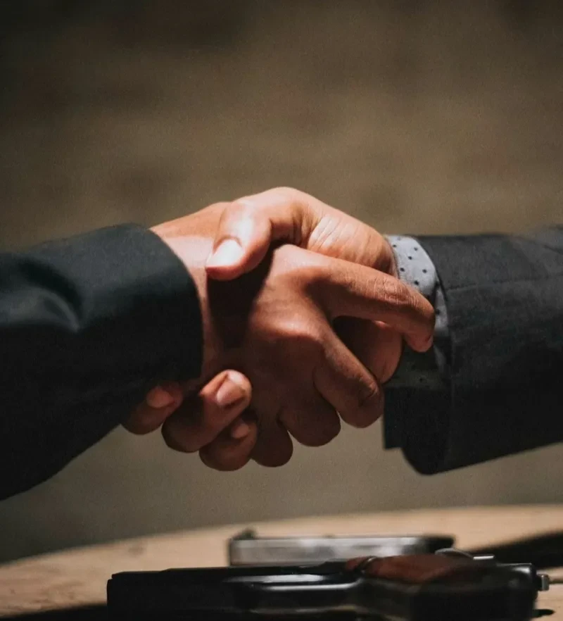 Professional handshake between two people in business attire, symbolizing agreement and dispute resolution through mediation in Missoula, Montana