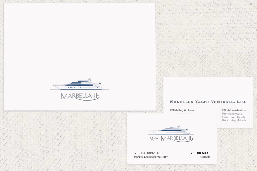 Marbella II boat logo with business cards displaying contact details for Marbella Yacht Ventures.