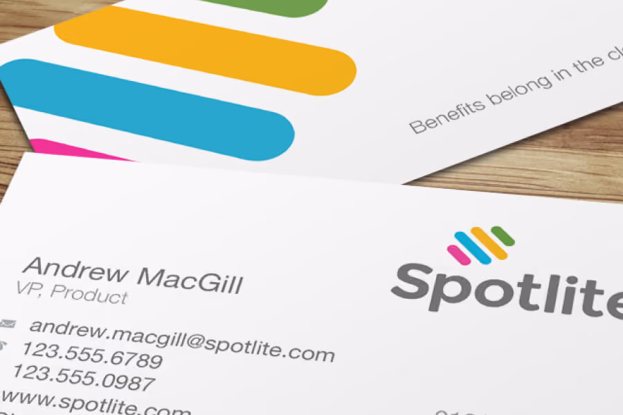 Close-up of Spotlite business card for Andrew MacGill, VP Product, showing contact details and logo.