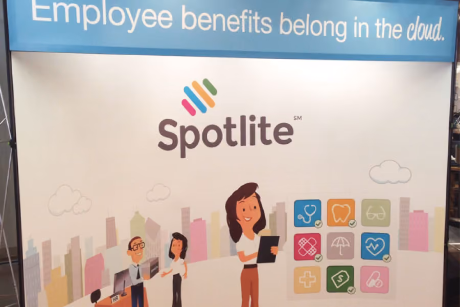 Spotlite banner showing cartoon employees with icons for benefits like health, dental, and wellness.