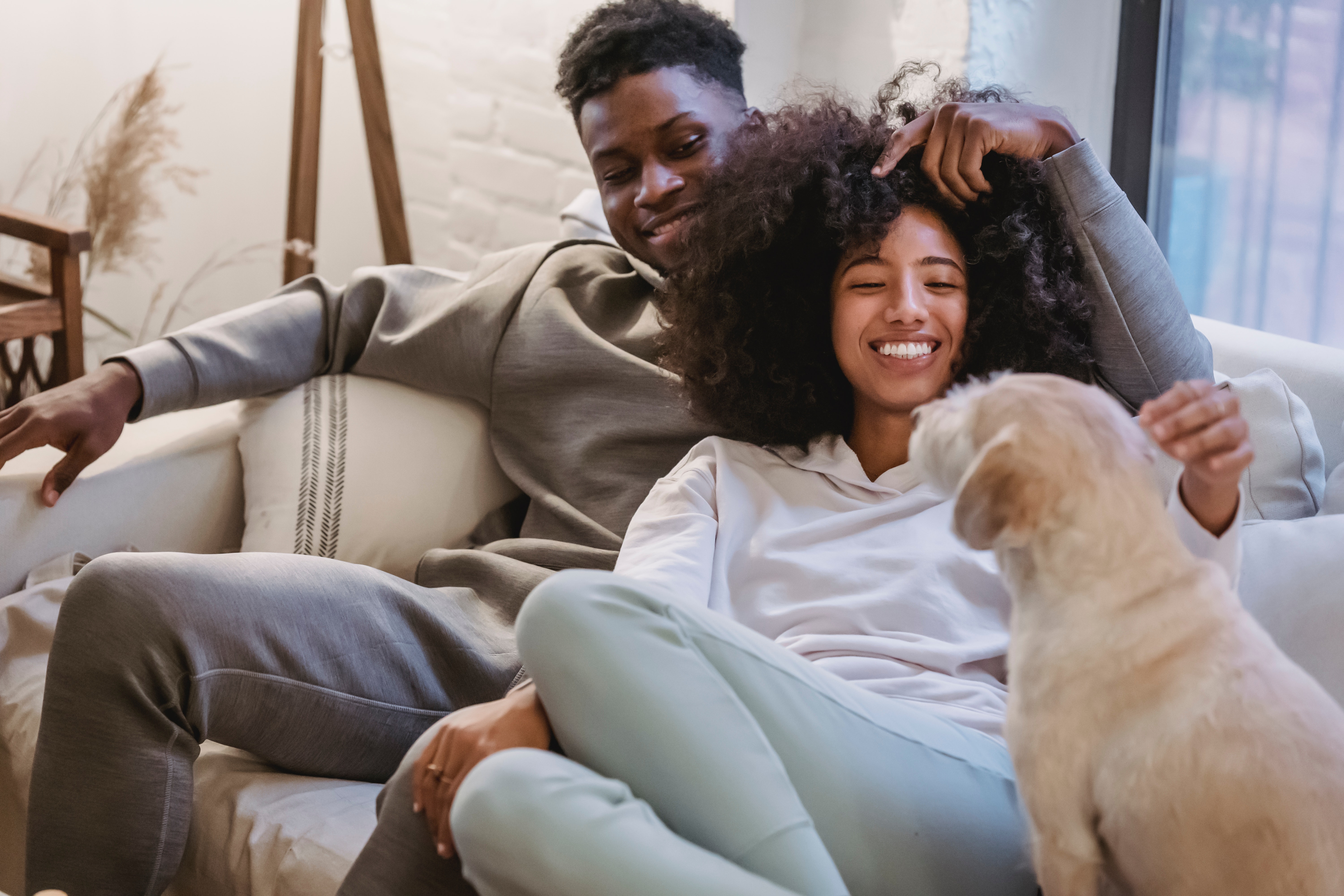 Girls playing video games on couch stock image