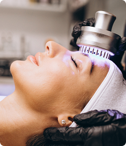 Woman receiving an exosome facial aesthetic treatment for skin rejuvenation and anti-aging
