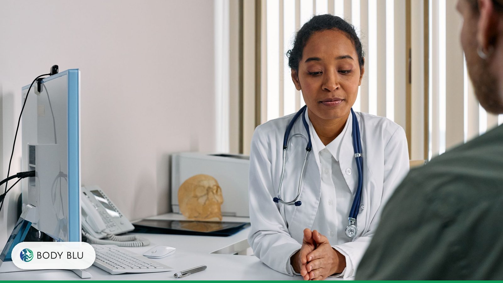 Doctor in a white coat with a stethoscope listening to a patient during a consultation about weight loss injections