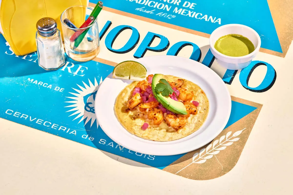 Sinaloa shrimp taco with melted cheese, pickled onions and avocado