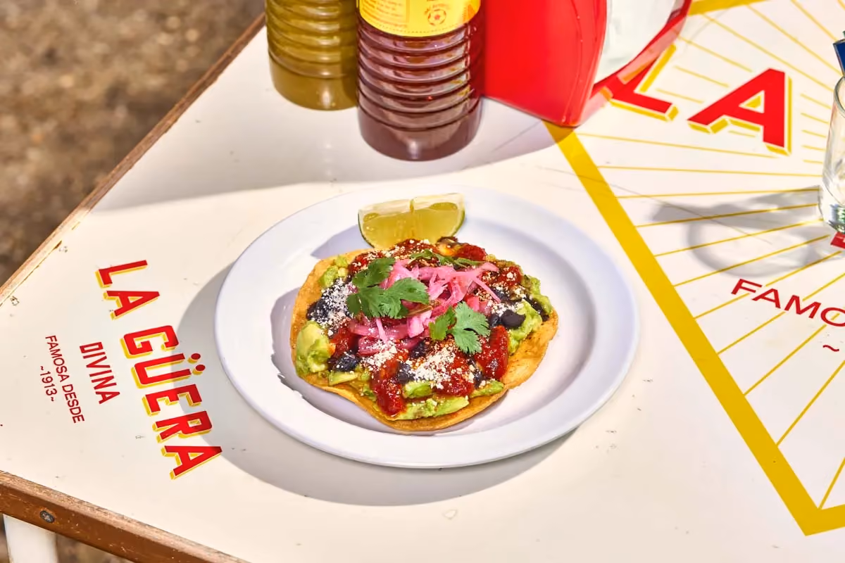Avocado tostada with black beans, pickled red onion and cotija cheese
