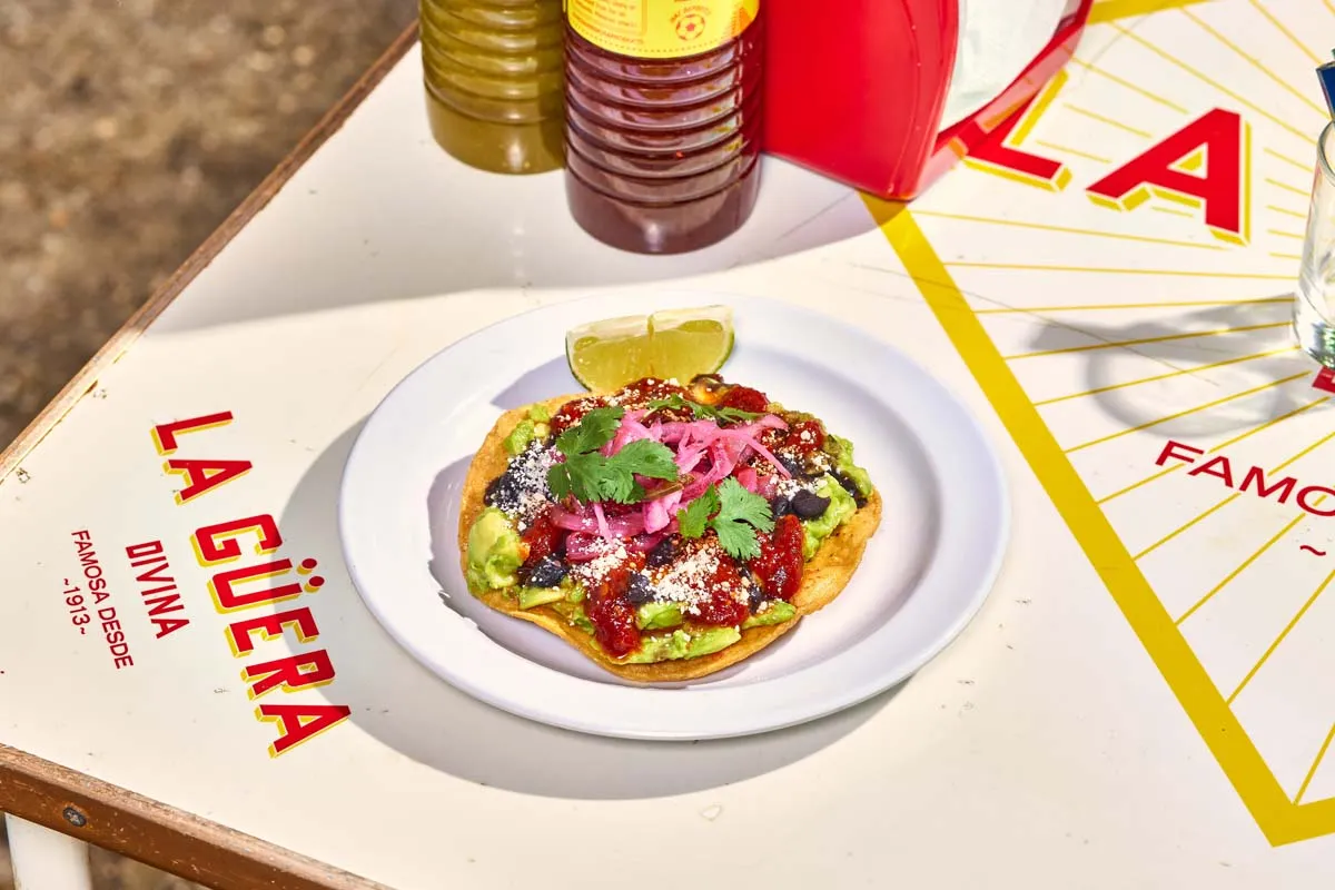 Avocado tostada with black beans, pickled red onion and cotija cheese