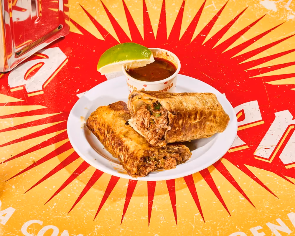 Birria burrito with braised brisket, melted cheese and black beans, served with consomé