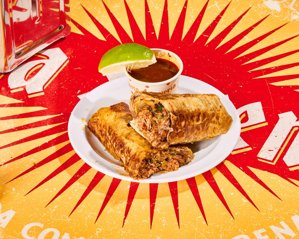 Birria burrito with braised brisket, melted cheese and black beans, served with consomé