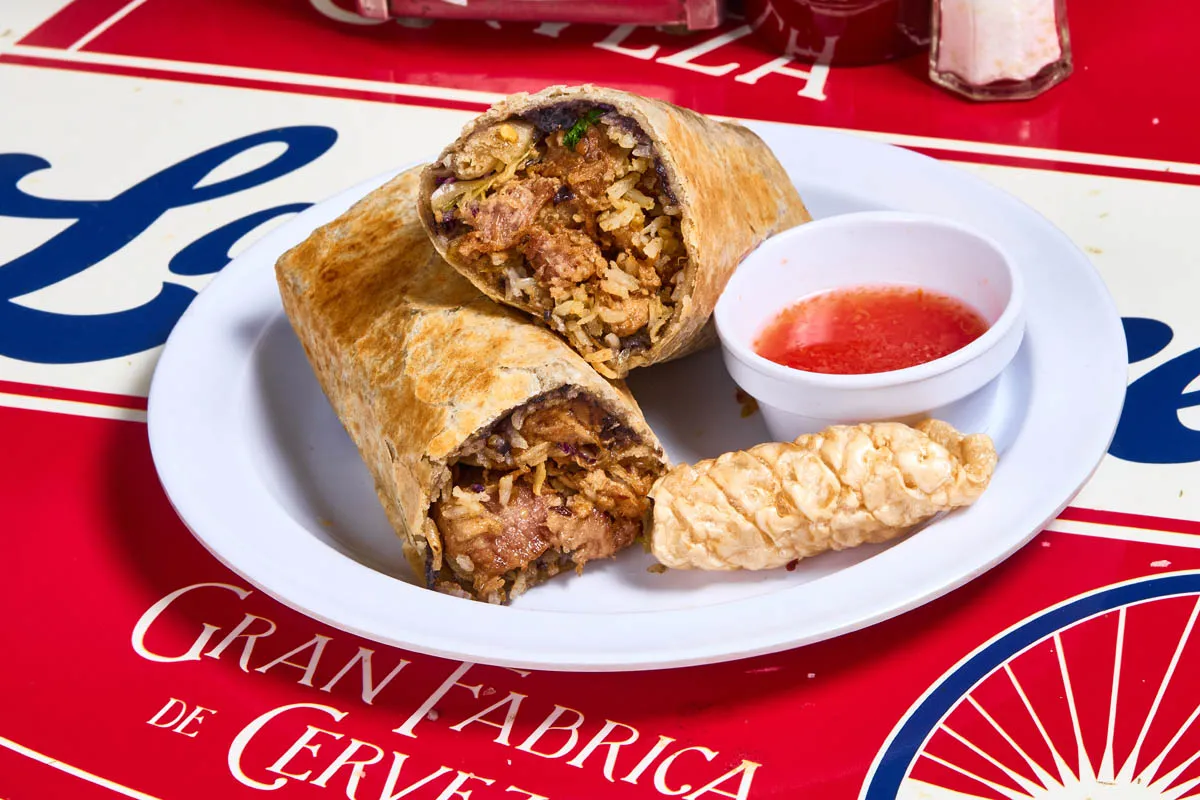 Carnitas burrito with slow-braised pork, rice, beans and crispy chicharrón