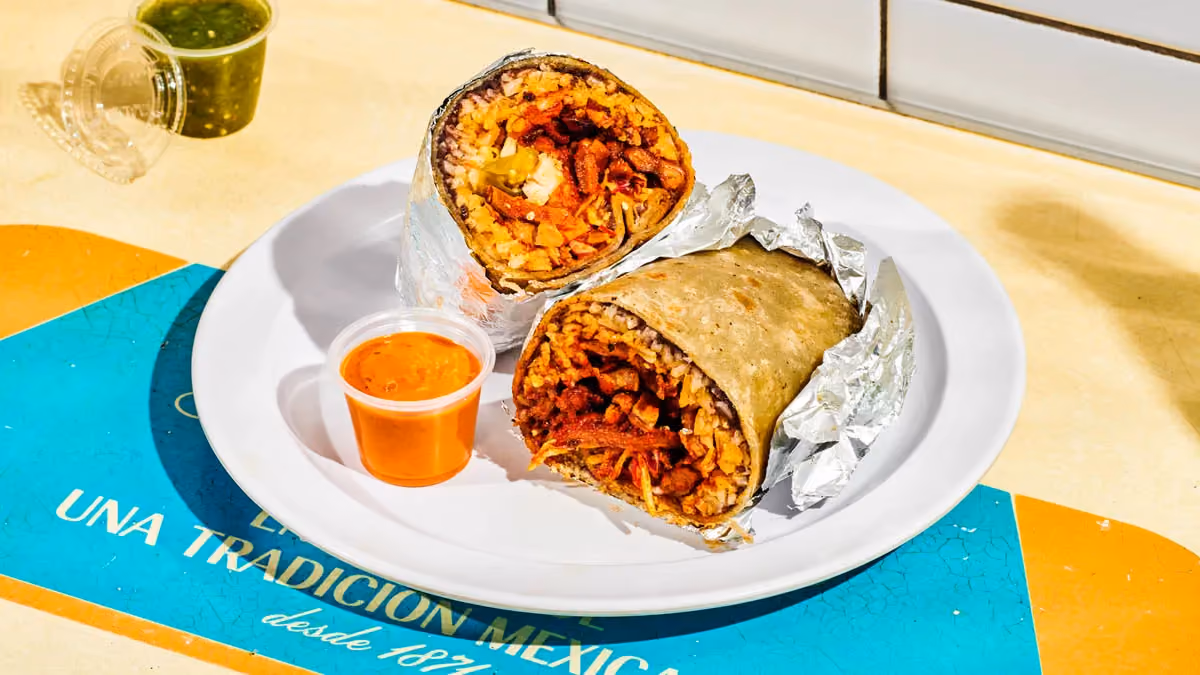 Al pastor burrito with roasted pork, rice, beans, cabbage and salsa