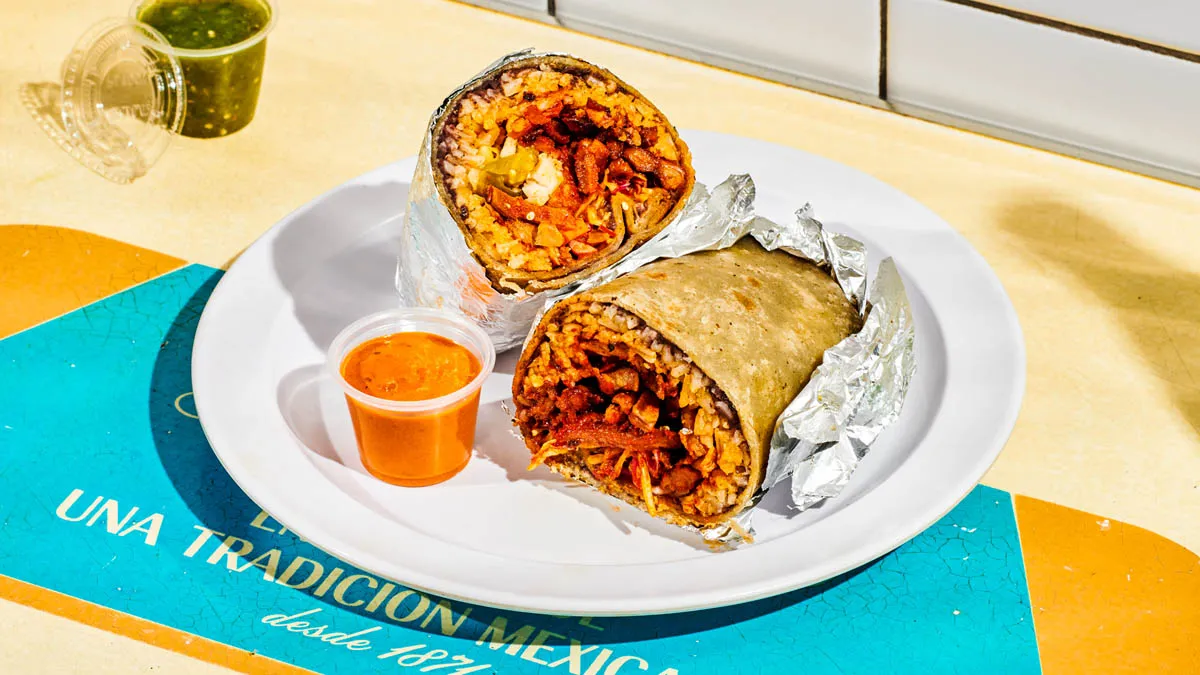 Al pastor burrito with roasted pork, rice, beans, cabbage and salsa