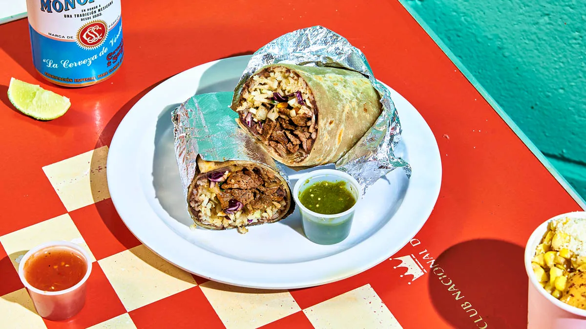 Carne asada burrito with seared beef, rice, beans, cabbage and salsa
