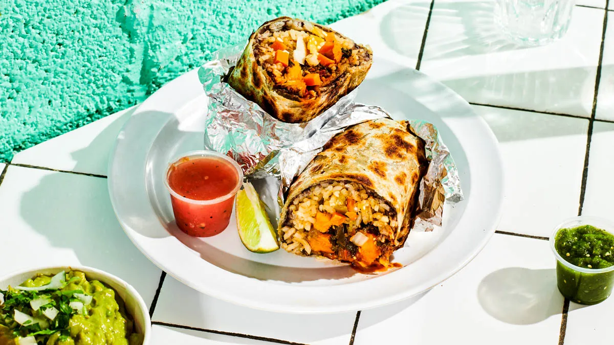 Vegana burrito with roasted sweet potato, kale, poblano rajas, rice and beans