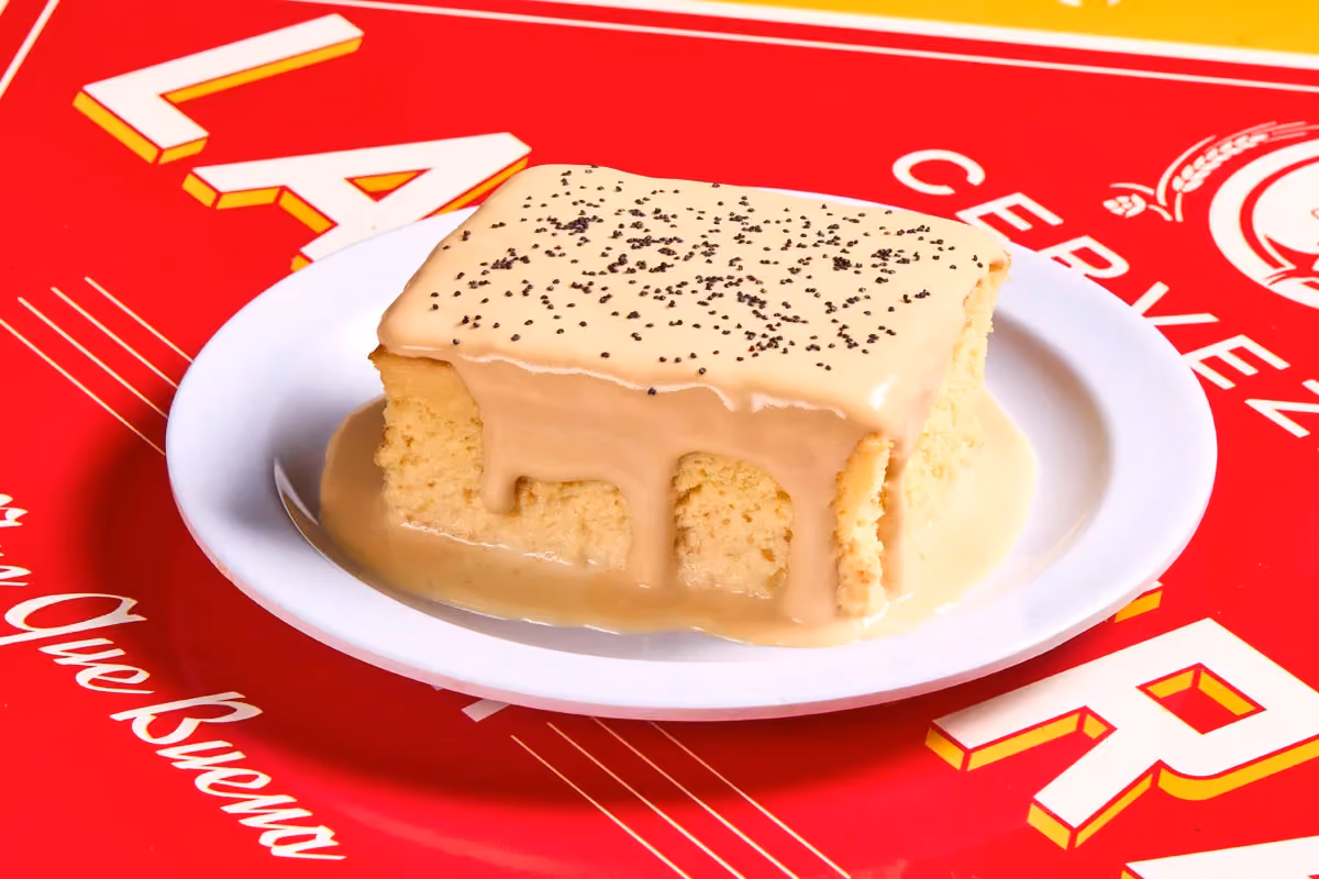 Tres leches cake soaked in three milks, topped with cajeta whipped cream and poppy seeds