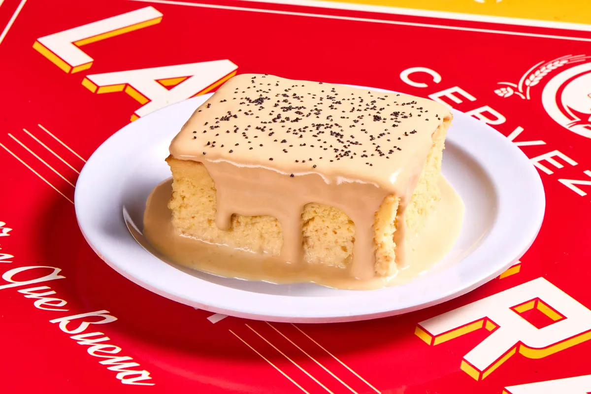 Tres leches cake soaked in three milks, topped with cajeta whipped cream and poppy seeds