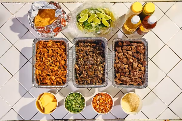 Make your own tacos with up to three delicious proteins, warm fresh corn tortillas and all of your favorite taqueria toppings. Includes pico de gallo, sliced pineapple, poblano mayo, Vista Hermosa roasted tomato salsa and green salsa, queso cotija, cilantro & onion, cabbage, and limes.