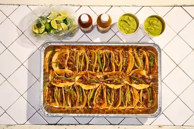 A top taco tray! 30 seared and chopped sirloin topped with caramelized onions, chiles toreados and fresh cilantro.