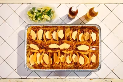 Transport your group to México in minutes. 30 'Al Pastor' tacos. With free-range pork, thinly sliced and marinated in chile and spices, slow-roasted on a trompo. The meat is sliced off the spit as it is cooked and each taco is topped with pineapple, cilantro, and diced onions.