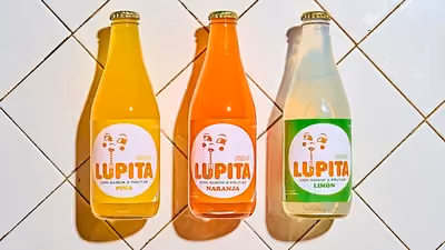 A mix of three vibrant, tropical fruit-based sodas