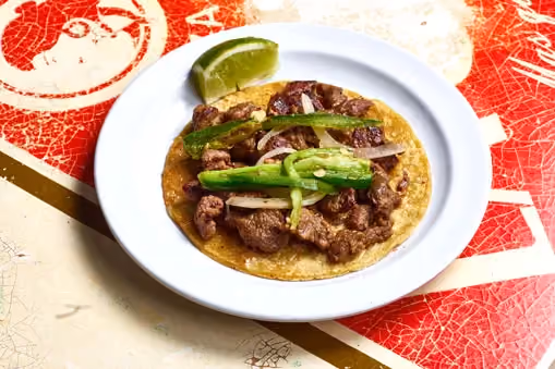 Carne asada taco with caramelized onions and chiles toreados