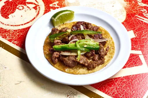 Carne asada taco with caramelized onions and chiles toreados
