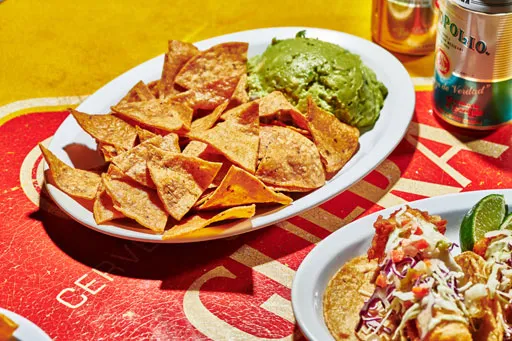 Guacamole con totopos made with Hass avocados, cilantro, jalapeño and lime