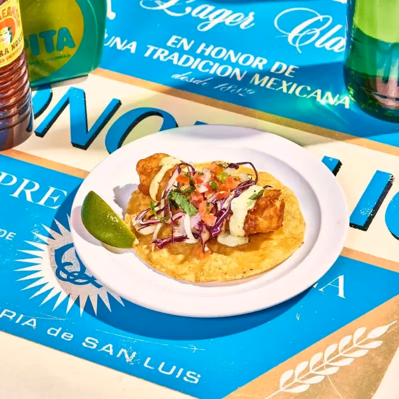 Baja crispy fish taco with beer-battered cod, pico de gallo, poblano mayo and pickled cabbage