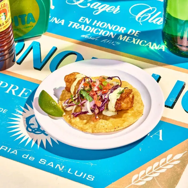 Baja crispy fish taco with beer-battered cod, pico de gallo, poblano mayo and pickled cabbage