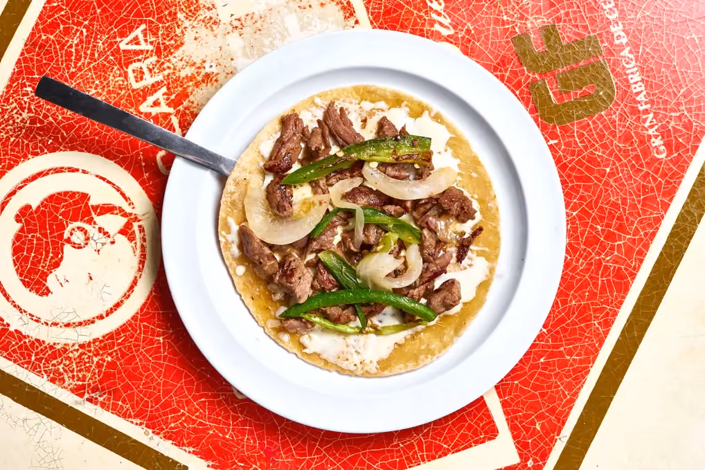 Carne asada quesadilla with caramelized onions, chiles toreados and melted cheese