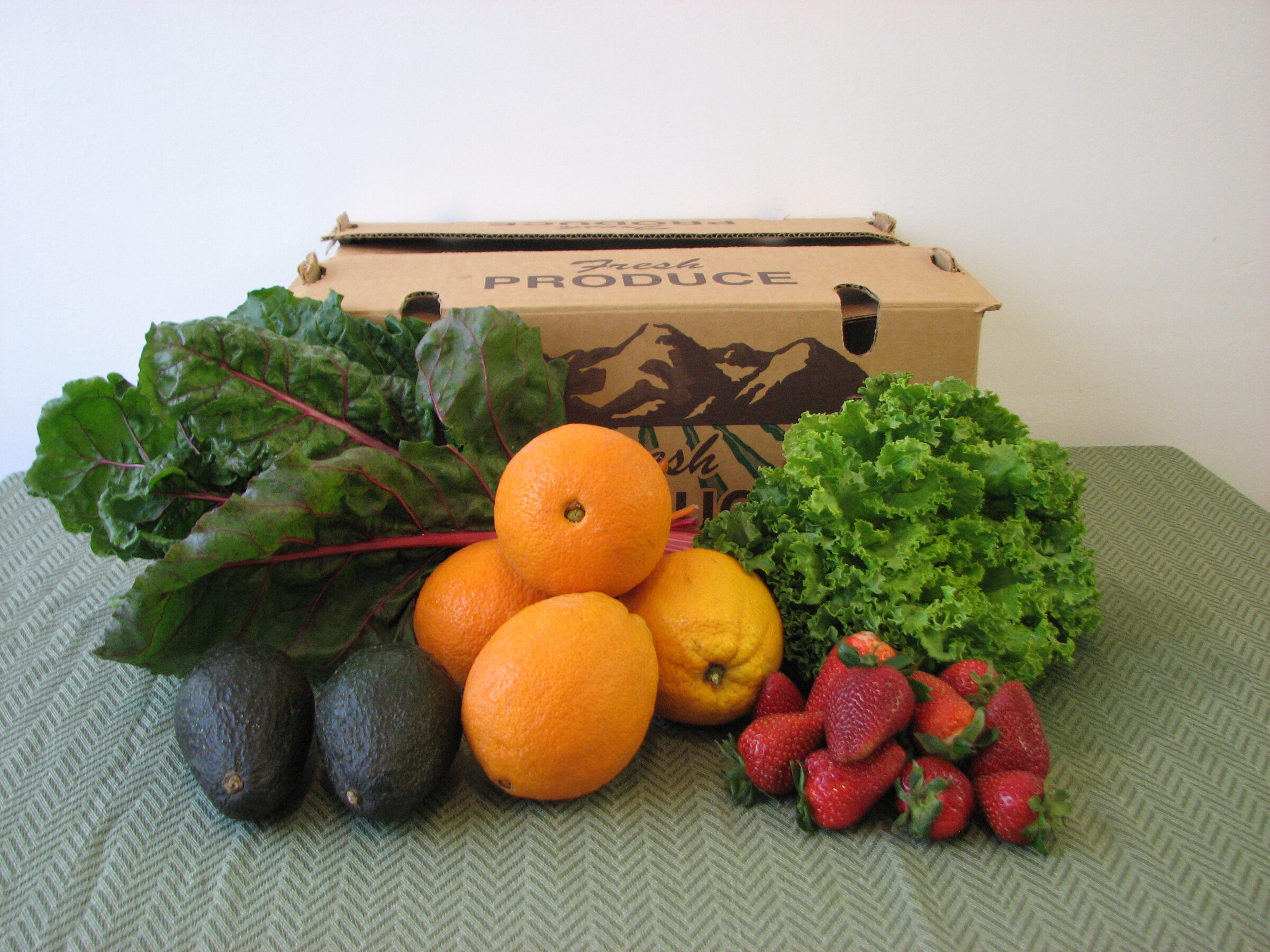 Basic Pick CSA box with chard, oranges, lettuce and strawberries from Eli's Farms
