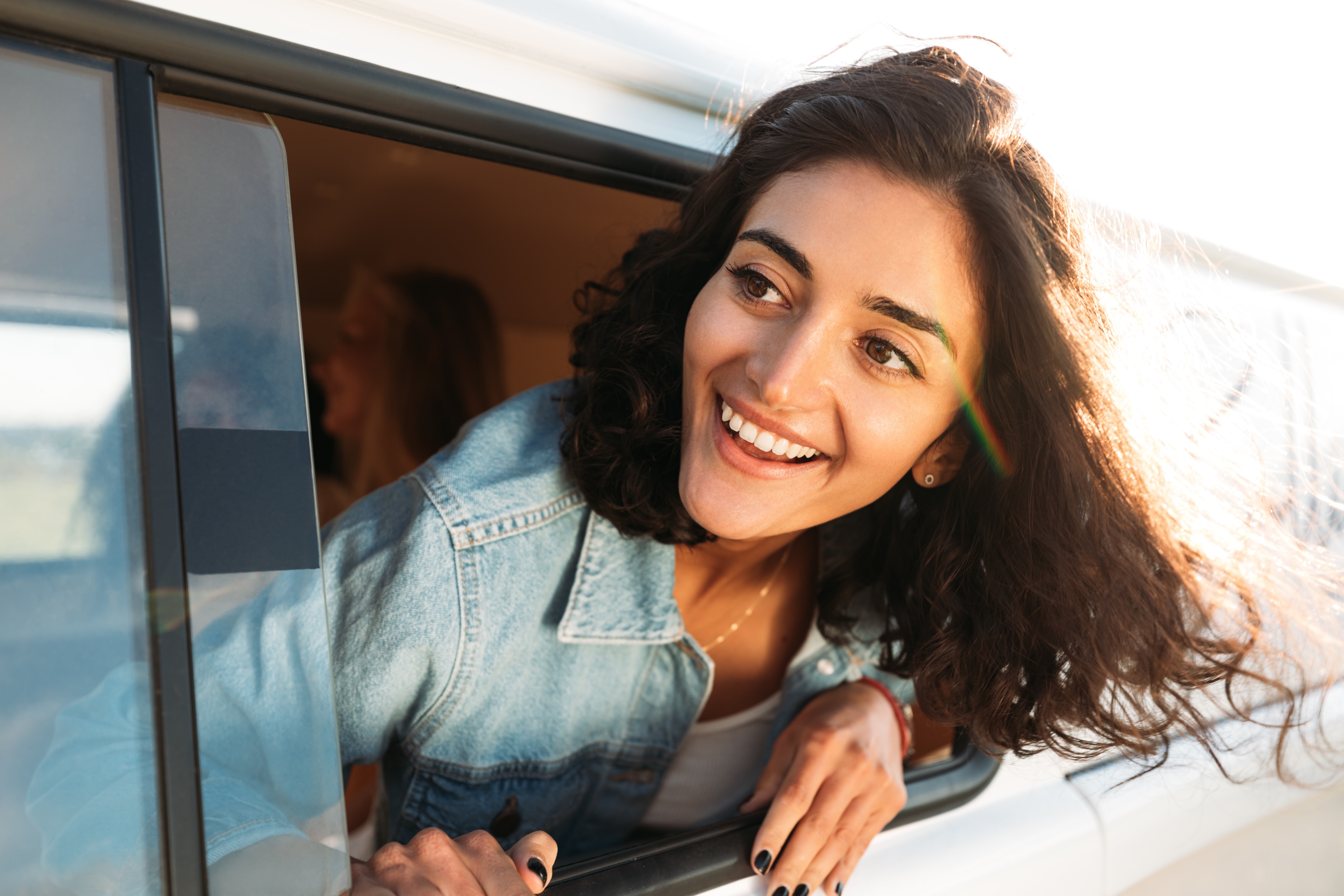 Girl with head out of car window stock image