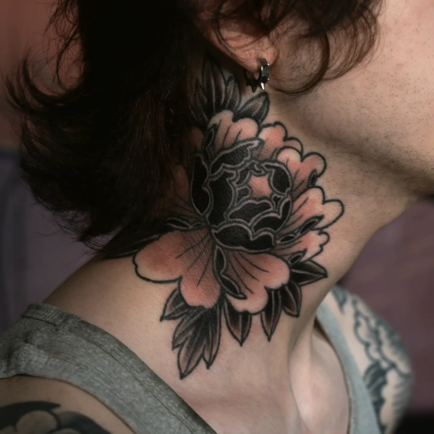 Healed traditional flower tattoo done on the neck
