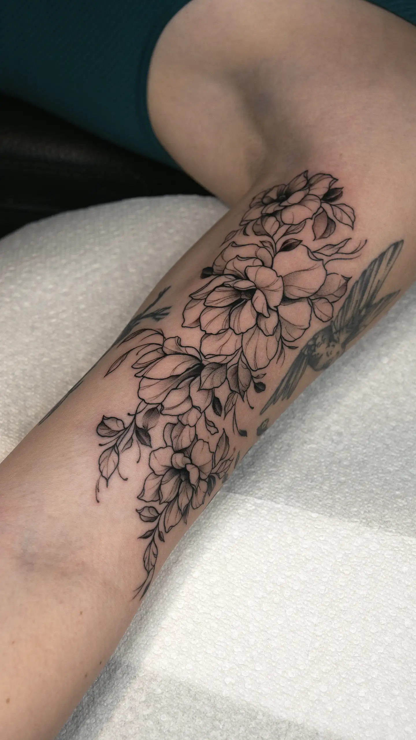Fine-line minimalist floral tattoo